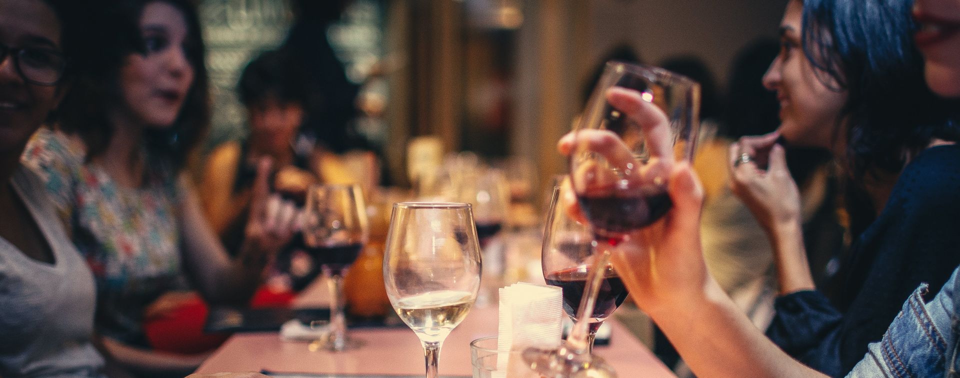 People Drinking Liquor and Talking on Dining Table Close-up Photo